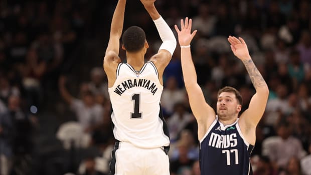 Luka Doncic does his best to contest Victor Wembanyama’s shot.